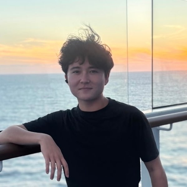 Haku smiling on a balcony at sunset